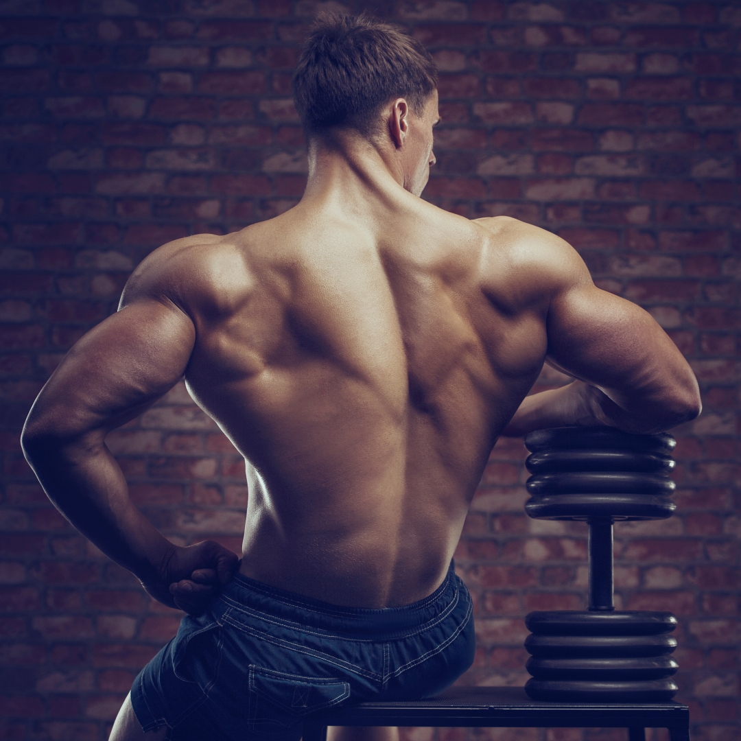 Bodybuilder strong man pumping up back muscles blank